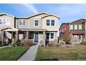 Charming two-story townhome with well-manicured lawn and inviting front porch, perfect for relaxing outdoors at 3061 Low Meadow Blvd, Castle Rock, CO 80109