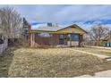 Cozy home with a brick facade, a small front yard, and a walkway leading up to the front door at 10705 Downing St, Northglenn, CO 80233