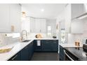 Modern kitchen featuring sleek cabinetry, countertops, and stainless steel appliances at 3055 S Bannock St, Englewood, CO 80110
