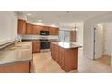 Spacious kitchen with an island, tile floors, stainless steel appliances, and lots of cabinet space at 4042 E Hinsdale Cir, Centennial, CO 80122