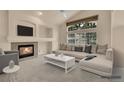 Comfortable living room featuring a fireplace, large windows, and ample seating at 4042 E Hinsdale Cir, Centennial, CO 80122