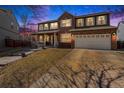 Charming two-story brick home with a covered front porch and well-maintained lawn and a two car garage at 5224 Snow Goose St, Brighton, CO 80601
