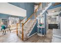 Inviting foyer with staircase and neutral tile flooring at 5224 Snow Goose St, Brighton, CO 80601