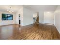 The living room features hardwood floors, white walls, and a view of the staircase at 1460 Belmont Dr, Longmont, CO 80503