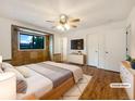 Comfortable main bedroom featuring hardwood floors, a decorative window, and ample closet space at 1460 Belmont Dr, Longmont, CO 80503