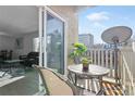 Enjoy the view from this cozy balcony with outdoor seating and a glimpse of the living room indoors at 7375 E Quincy Ave # 204, Denver, CO 80237