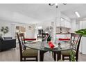 Dining area with glass table and four chairs, and chandelier at 7375 E Quincy Ave # 204, Denver, CO 80237