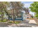 This two-story home has a welcoming front porch, long driveway, and well-maintained yard at 511 Noel Ave, Longmont, CO 80501