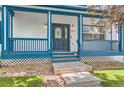 Close-up of the home's charming front porch with decorative railings and a stylish front door at 511 Noel Ave, Longmont, CO 80501