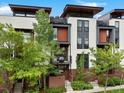 Modern multi-story townhouse with eye-catching architectural details, lush landscaping, and inviting entrance at 1880 W 32Nd Ave, Denver, CO 80211