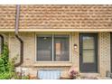 Close-up of the exterior showing the front door and window with brick detail at 12931 W 20Th Ave, Golden, CO 80401