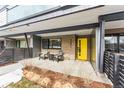 Inviting front porch with yellow door and two comfy chairs at 2471 Walnut St, Boulder, CO 80302