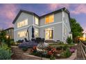 The backyard has a well-maintained garden, patio furniture, beautiful landscaping, and a sculpture at 5984 S Paris Pl, Greenwood Village, CO 80111