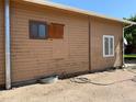 Rustic home featuring wood siding, small windows and unfinished trim at 1000 Denver Ave, Fort Lupton, CO 80621