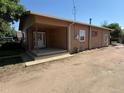 Rustic home featuring covered porch and gravel yard at 1000 Denver Ave, Fort Lupton, CO 80621