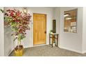 Inviting condo entry with wood door and tasteful decor at 31819 Rocky Village Dr # 216, Evergreen, CO 80439