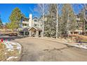 Building exterior showcasing the entrance and landscaping at 31819 Rocky Village Dr # 216, Evergreen, CO 80439