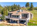 Stunning home showcasing a tile roof, multiple balconies, and panoramic views at 33448 Alta Vista Dr, Evergreen, CO 80439