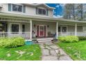 Inviting front porch with stone pathway, decorative planters, and well maintained greenery at 18470 Canterbury Dr, Monument, CO 80132