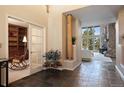 Spacious foyer with tile floors and a view into the living room with large windows and a stone fireplace at 23 Hess Ave, Golden, CO 80401