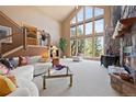 Bright living room featuring a soaring ceiling, a wall of windows, and a stone fireplace at 23 Hess Ave, Golden, CO 80401