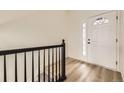 Bright entryway with wood-look flooring and modern front door with glass at 3200 S Federal Blvd # 5, Denver, CO 80236