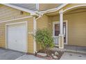 Close up of exterior of condo showing private garage and charming entrance at 3200 S Federal Blvd # 5, Denver, CO 80236