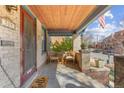 Inviting covered front porch with chairs, table, and a warm welcome mat at 525 N Pearl St, Denver, CO 80203