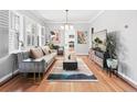 Spacious living room featuring hardwood floors, large windows, and modern decor at 525 N Pearl St, Denver, CO 80203