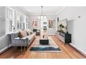 Bright living room with hardwood floors, gray sofa, and modern decor, bathed in natural light at 525 N Pearl St, Denver, CO 80203