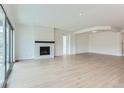 Bright living room featuring a modern fireplace, light hardwood floors, and ample natural light at 34 Leafy Aster Ln, Castle Rock, CO 80104