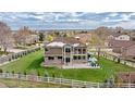 Expansive backyard with white fence, large patio, and well-manicured lawn at 14461 Inca Ct, Westminster, CO 80023