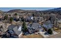 An aerial view showcasing the home and its neighborhood with picturesque mountain views at 69 Dawn Heath Cir, Littleton, CO 80127