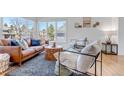 Cozy living room with a leather sofa, modern chairs, and lots of natural light at 69 Dawn Heath Cir, Littleton, CO 80127