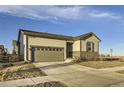 Single Gathering home with a two-car garage, siding and stone accents plus a paved drive at 18187 E 99Th Ave, Commerce City, CO 80022