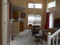 Bright, open-concept living room with a fireplace, high ceilings, and dining area at 19692 E Mann Creek Dr # D, Parker, CO 80134