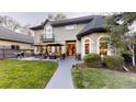 A backyard patio offers outdoor seating, a fire pit, grill and well-maintained lawn for gatherings and relaxation at 1160 Monaco Pkwy, Denver, CO 80220