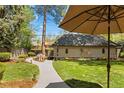 Beautifully landscaped backyard with a stone walkway and manicured garden beds at 1160 Monaco Pkwy, Denver, CO 80220