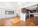 Open floor plan showcasing hardwood floors, natural light, and seamless flow into the modern kitchen at 5661 E Amherst Ave, Denver, CO 80222