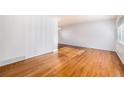 Bright living room featuring gleaming hardwood floors, fresh paint, and large windows at 5661 E Amherst Ave, Denver, CO 80222