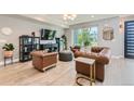 Bright living room featuring hardwood floors, chesterfield sofas, and lots of light at 6058 Beeler Ct, Denver, CO 80238