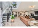 Open concept living room with hardwood floors, a staircase, and modern decor at 6058 Beeler Ct, Denver, CO 80238