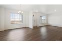 Bright living room featuring wood floors, white walls and large windows at 28610 E 8Th Pl, Watkins, CO 80137