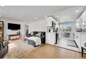 Bright, open-concept living room with a view to the well-appointed kitchen and modern appliances at 2544 S Raleigh St, Denver, CO 80219