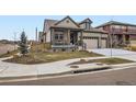 Attractive home exterior featuring a well-kept lawn, mature tree, and a two-car garage at 152 Western Sky Cir, Longmont, CO 80501