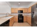 Well-lit kitchen with stainless steel appliances and neutral-toned cabinetry at 5255 Memphis St # 219, Denver, CO 80239