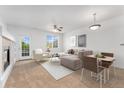 Cozy living room featuring neutral tones, a fireplace, and bright natural lighting at 5255 Memphis St # 219, Denver, CO 80239