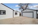 Spacious backyard featuring a detached garage and additional storage at 766 Fulton Ave, Brighton, CO 80601