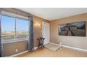 Inviting living room with a large window offering plenty of natural light and features modern light fixtures at 766 Fulton Ave, Brighton, CO 80601