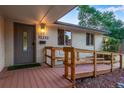 The front door is accessible via a wooden ramp, providing convenience and accessibility to the home at 12292 W 65Th Ave, Arvada, CO 80004